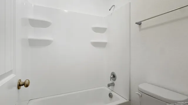 a bathroom with a shower and a toilet