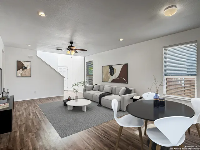 a living room with furniture and kitchen view