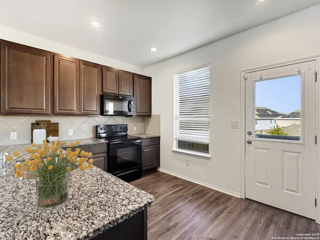 a kitchen with a stove a sink and a refrigerator