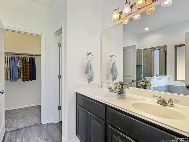 a bathroom with a sink a chandelier and a mirror