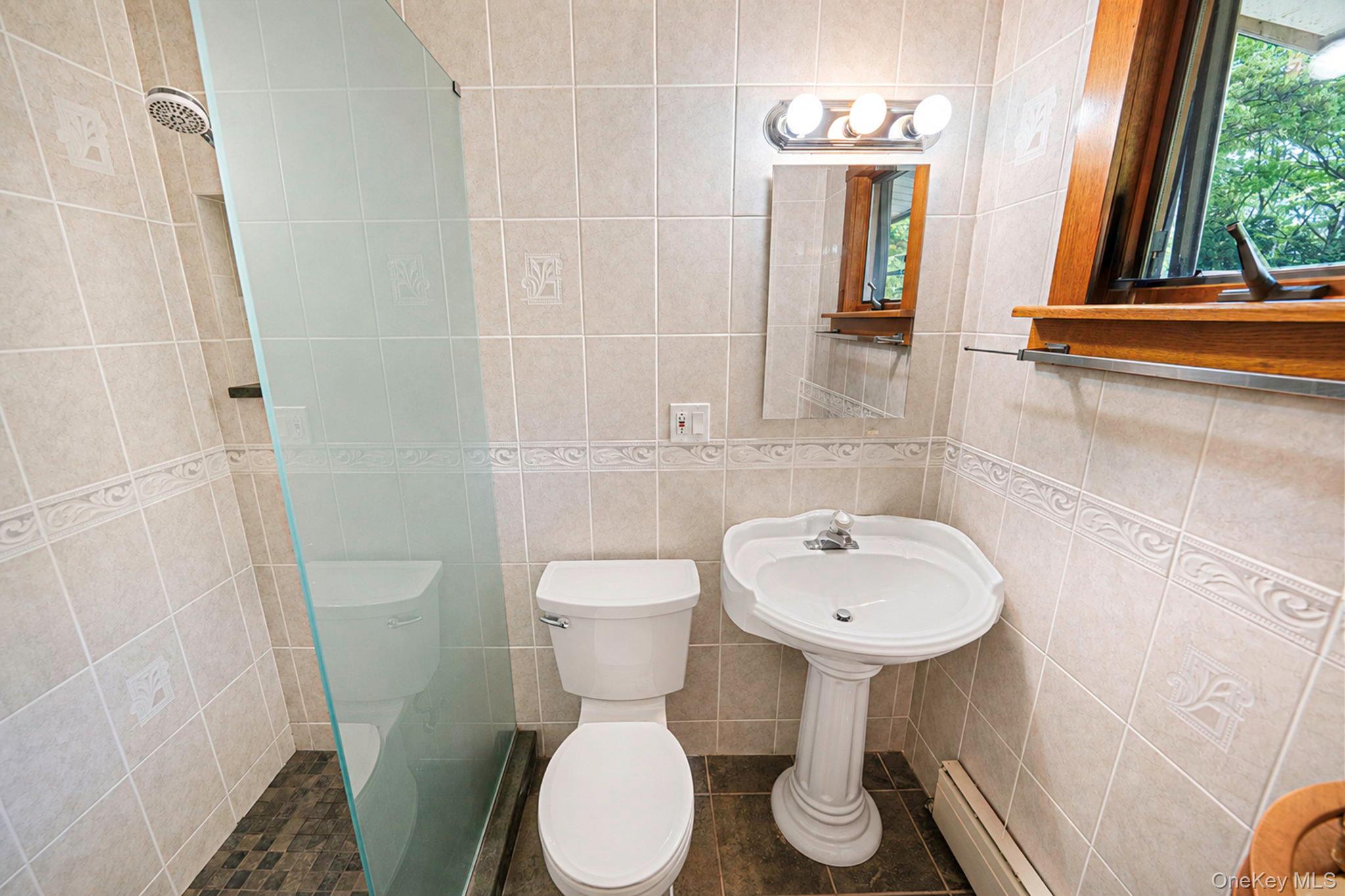 280 Deforest Road North Dix Hills, NY 11746 - Photo 27 of 37 a bathroom with a toilet sink and mirror