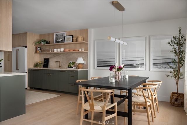 a kitchen with a table chairs stove and cabinets