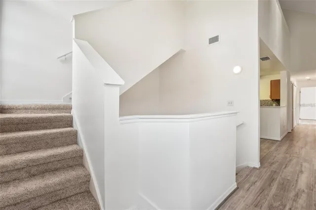 a view of a hallway with wooden floor and entryway