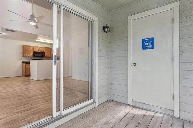 a view of a hallway view with wooden floor and staircase