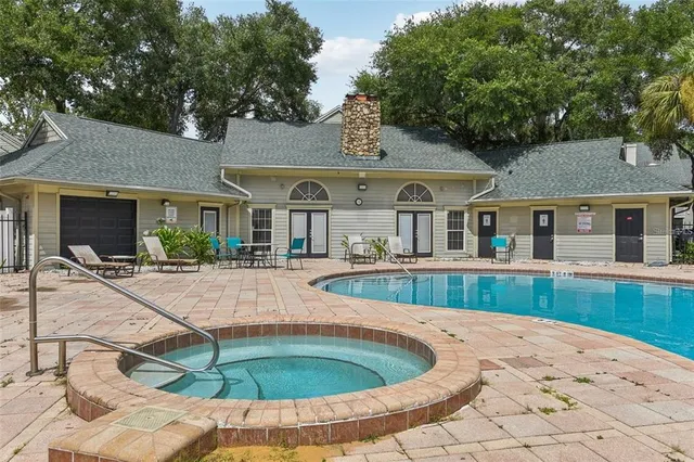 a view of house with swimming pool and furniture