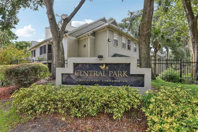 a view of a street sign under a large tree