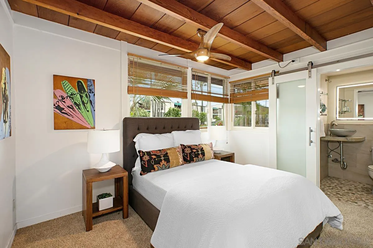 6243 Dowling Drive La Jolla, CA 92037 - Photo 16 of 28 a bedroom with a bed and a table