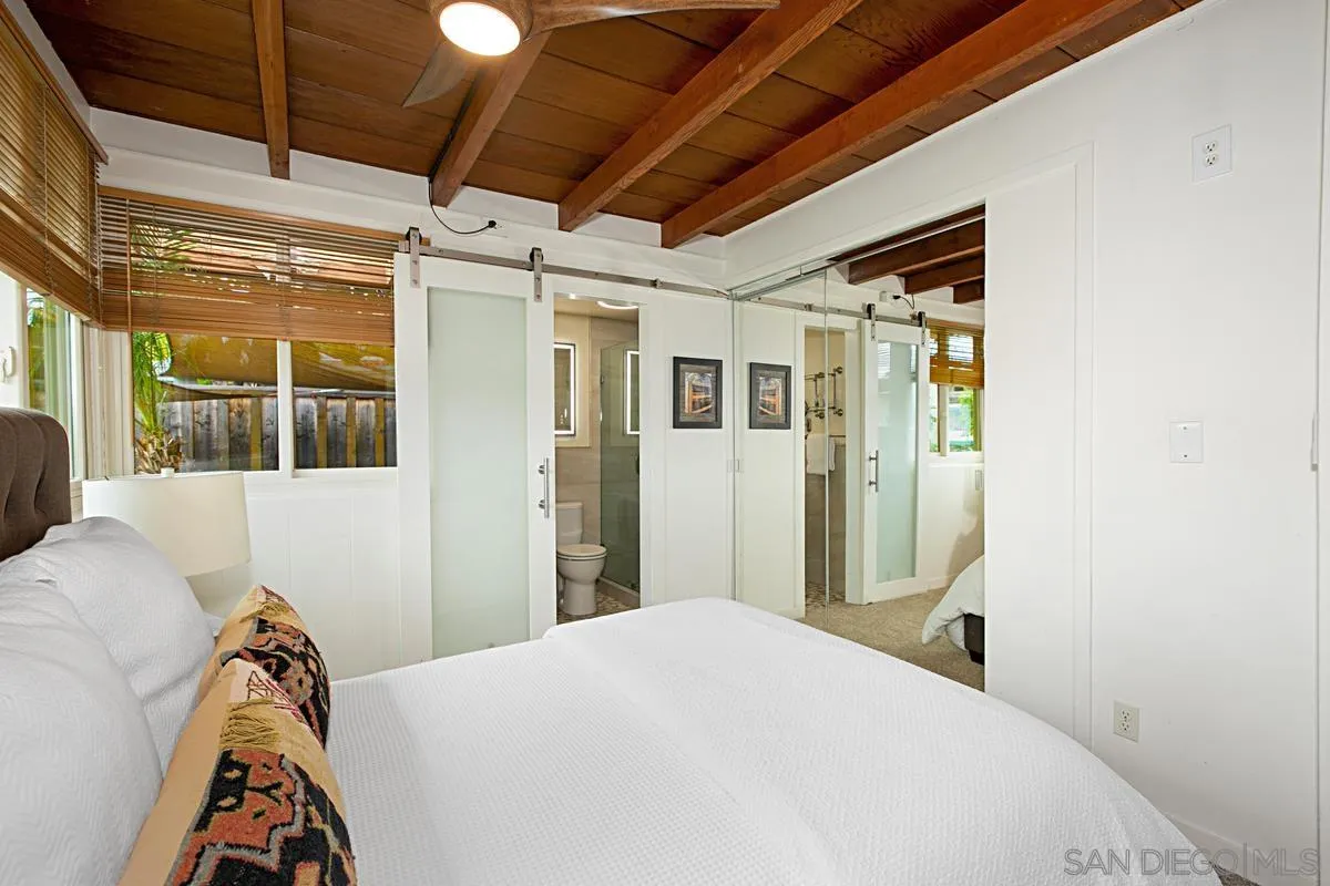 6243 Dowling Drive La Jolla, CA 92037 - Photo 17 of 28 a bedroom with a bed and a window