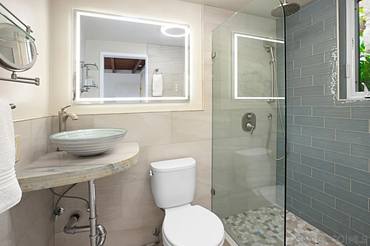 6243 Dowling Drive La Jolla, CA 92037 - Photo 18 of 28 a bathroom with a toilet a sink and shower