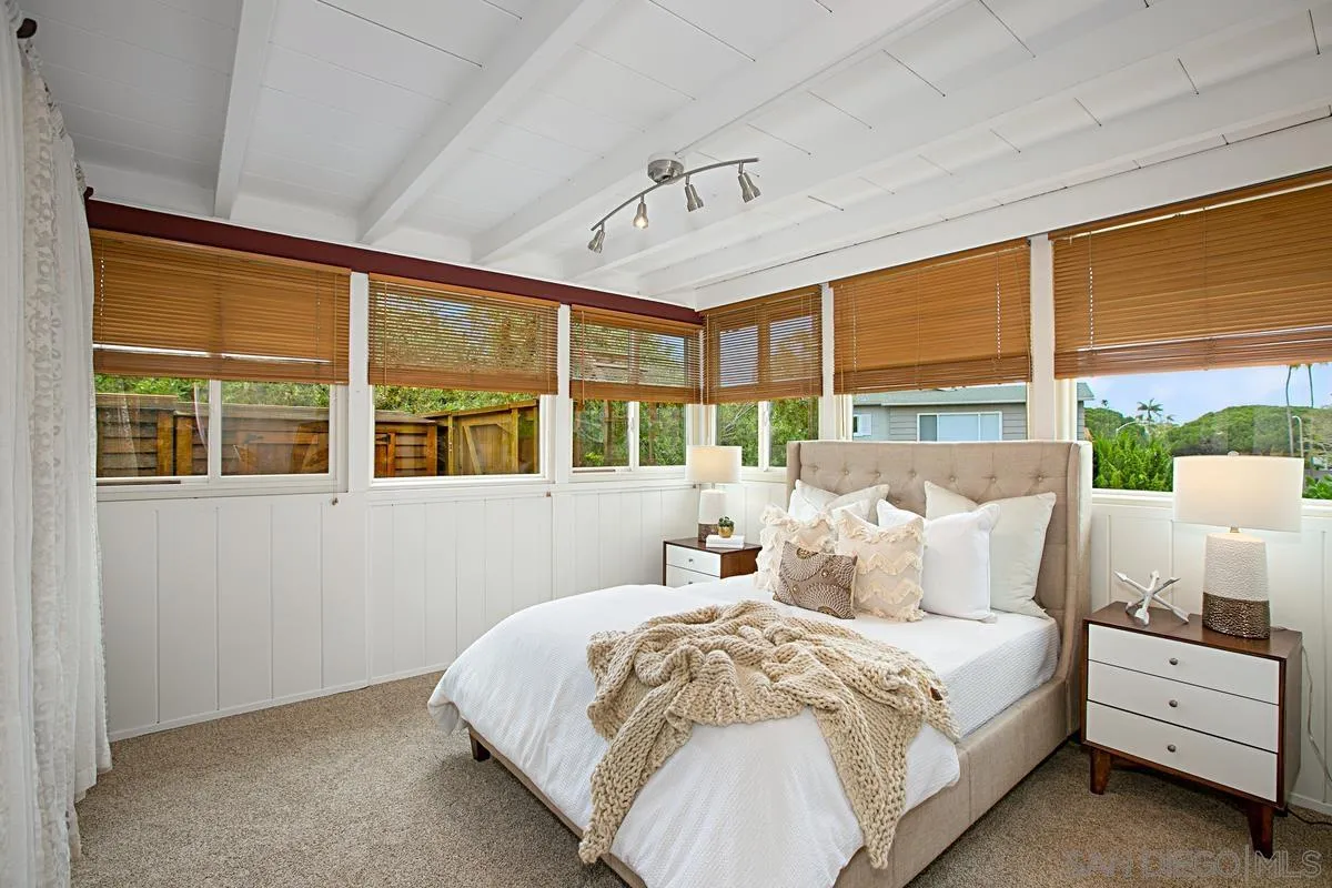 6243 Dowling Drive La Jolla, CA 92037 - Photo 19 of 28 a bedroom with a large bed and a large window
