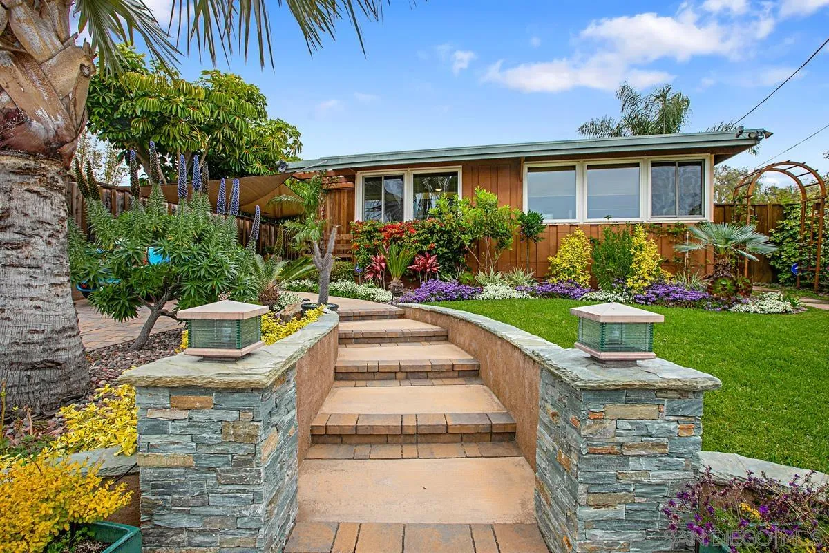 6243 Dowling Drive La Jolla, CA 92037 - Photo 2 of 28 a front view of a house with a yard