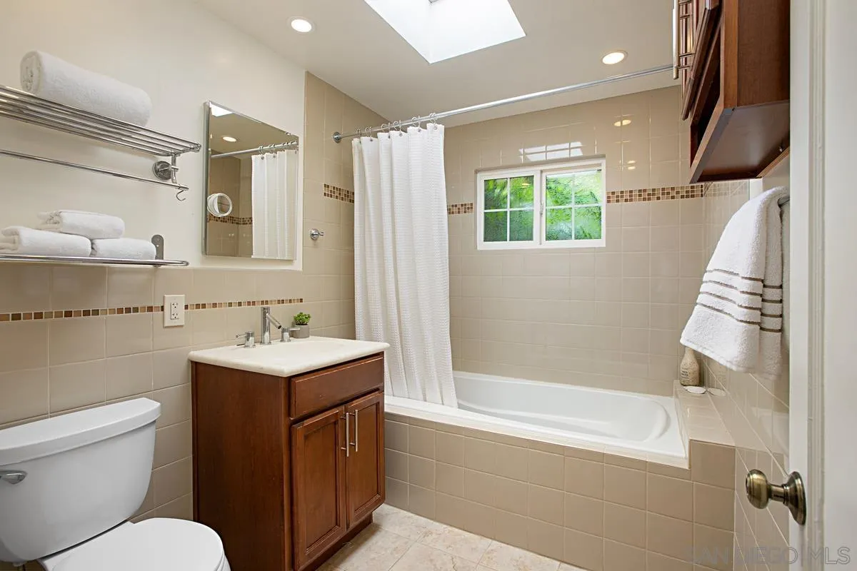 6243 Dowling Drive La Jolla, CA 92037 - Photo 21 of 28 a bathroom with a toilet sink and mirror