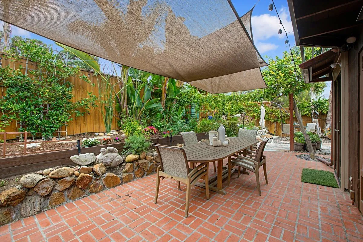 6243 Dowling Drive La Jolla, CA 92037 - Photo 22 of 28 a view of a patio with table and chairs potted plants and large tree