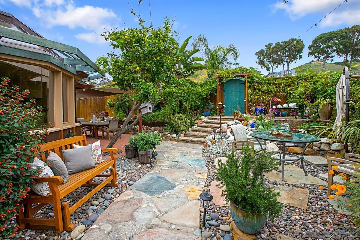 6243 Dowling Drive La Jolla, CA 92037 - Photo 26 of 28 a view of a chairs and table in a backyard