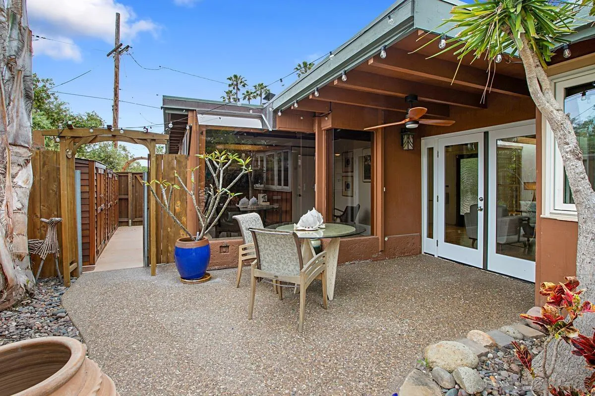 6243 Dowling Drive La Jolla, CA 92037 - Photo 27 of 28 a view of a patio with table and chairs potted plants with wooden floor