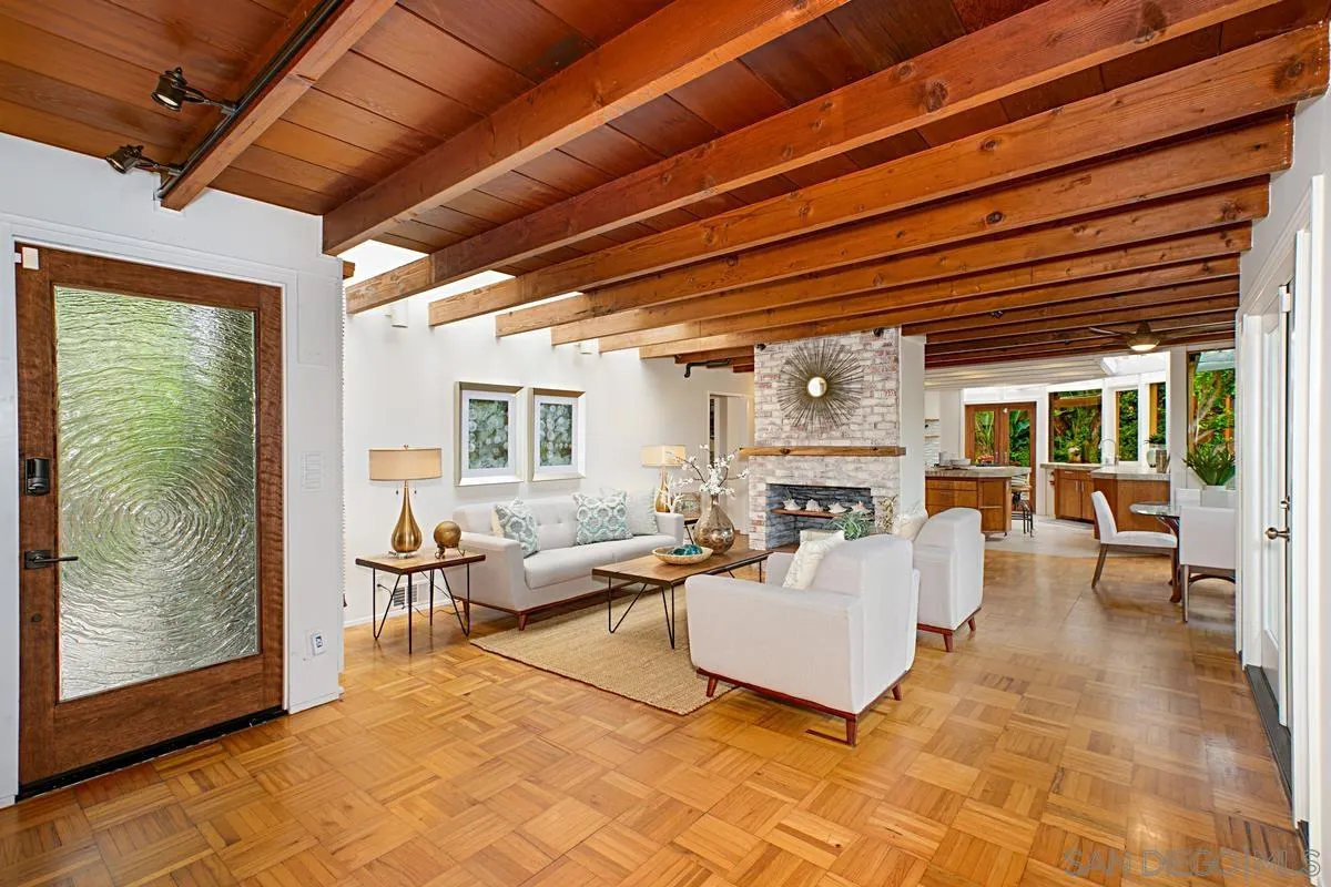 6243 Dowling Drive La Jolla, CA 92037 - Photo 6 of 28 a living room with patio furniture and a fireplace