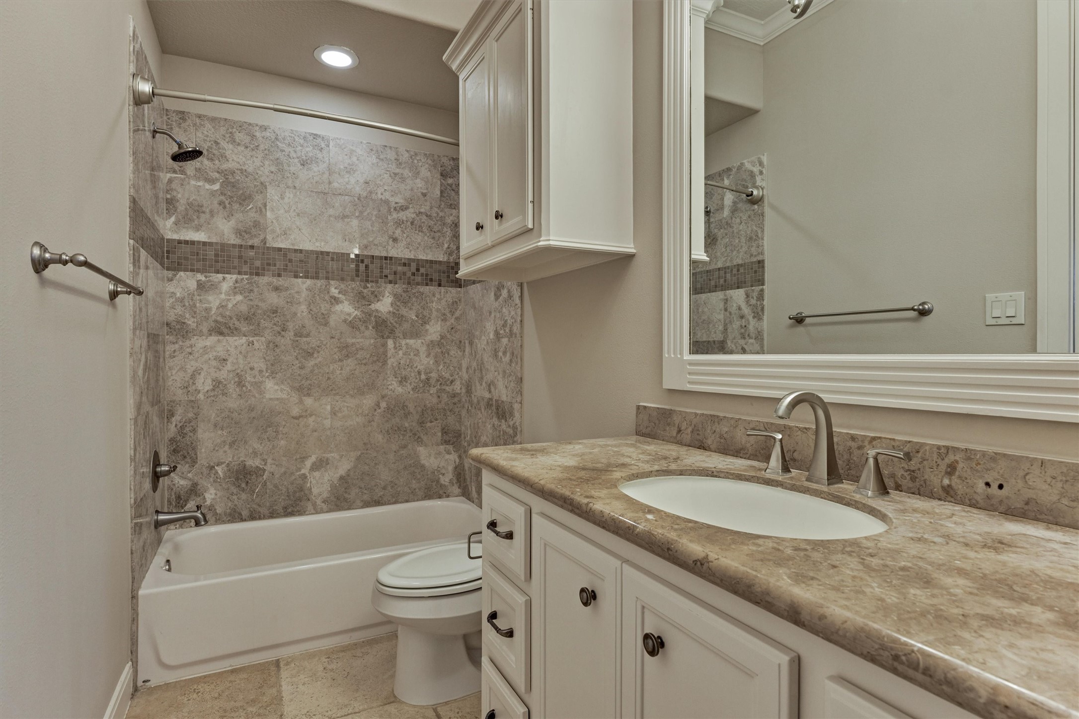 25 Post Shadow Estate Drive Spring, TX 77389 - Photo 39 of 49 Spa-inspired bathroom with tile-surround tub, granite vanity, and crisp cabinetry under bright recessed lighting.