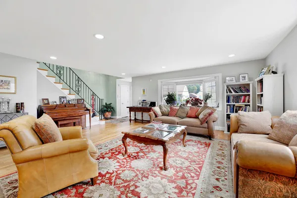a living room with furniture a rug and a flat screen tv