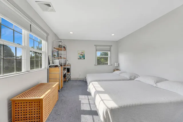 a bedroom with furniture and a window