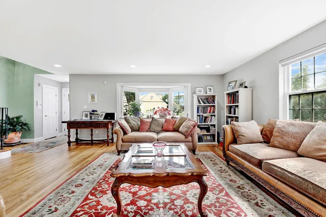 a living room with furniture a couch and a bookshelf