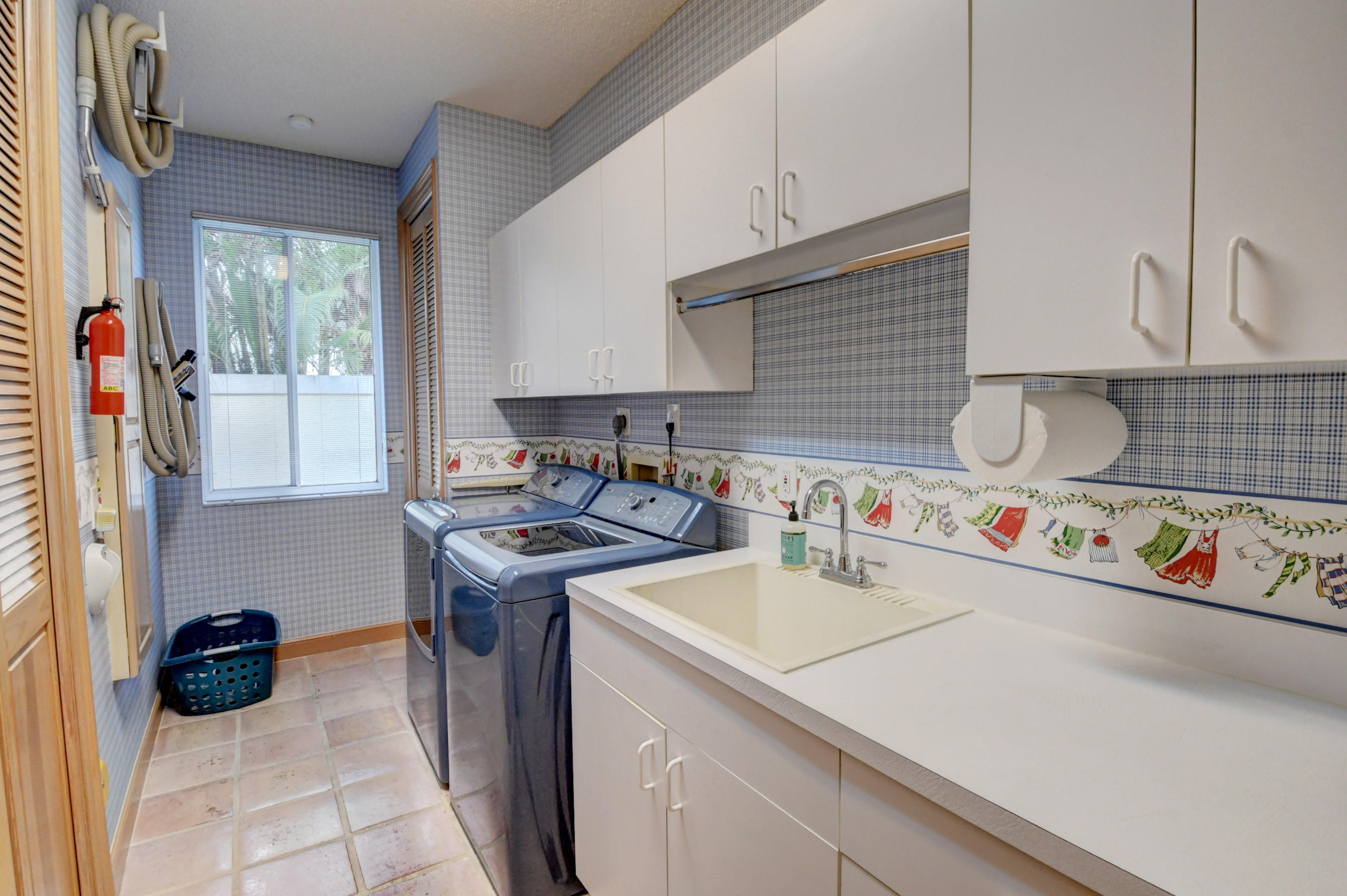 3196 Northwest 60th Street Boca Raton, FL 33496 - Photo 43 of 65 a utility room with cabinets a washer and dryer