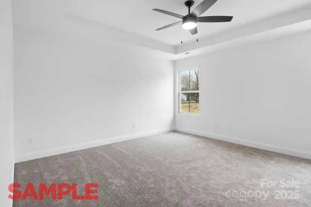 an empty room with fan and windows