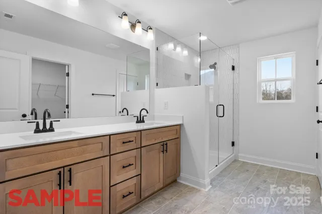 a spacious bathroom with double sink and a mirror