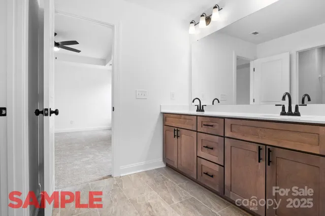 a bathroom with a double vanity sink mirror and shower