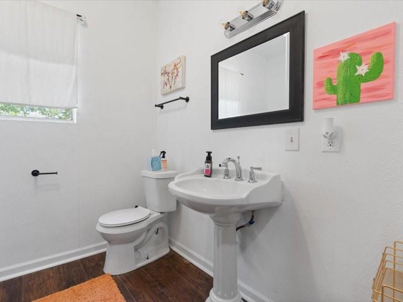 809 East Adams Street Itasca, TX 76055 - Photo 13 of 31 a bathroom with a sink mirror and toilet