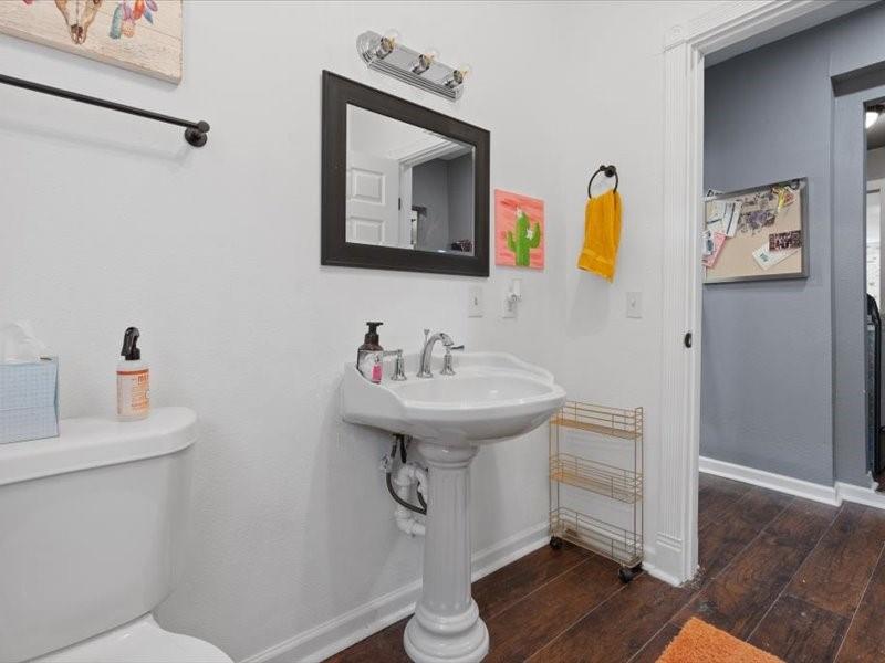 809 East Adams Street Itasca, TX 76055 - Photo 14 of 31 a bathroom with a sink and a mirror