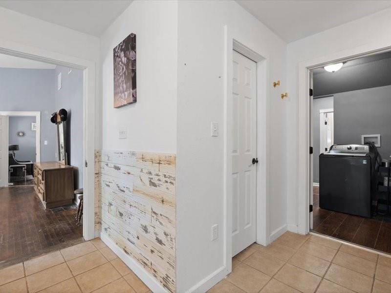 809 East Adams Street Itasca, TX 76055 - Photo 19 of 31 a view of a hallway with cabinets and wooden floor