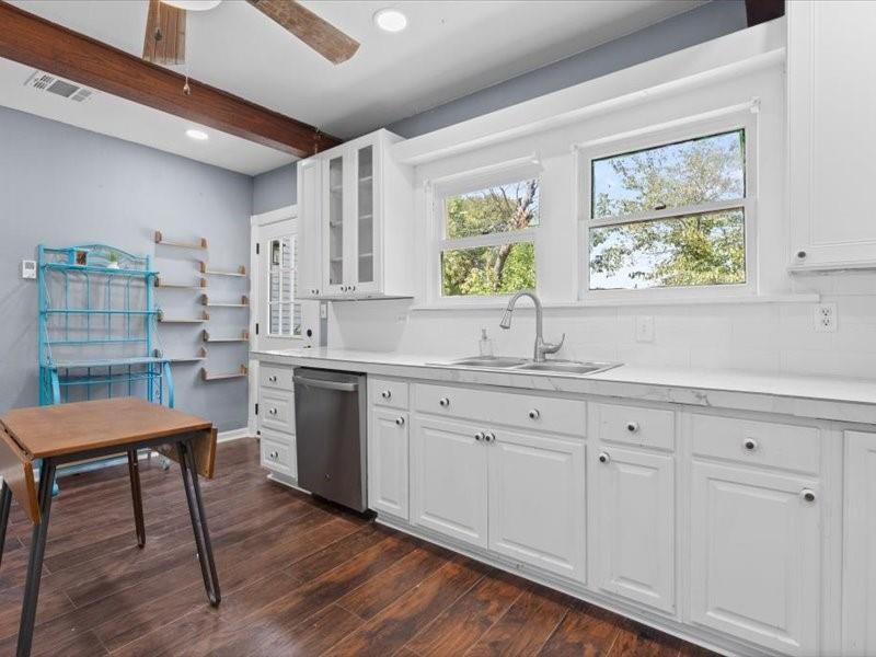 809 East Adams Street Itasca, TX 76055 - Photo 23 of 31 a kitchen with granite countertop white cabinets a sink and dishwasher