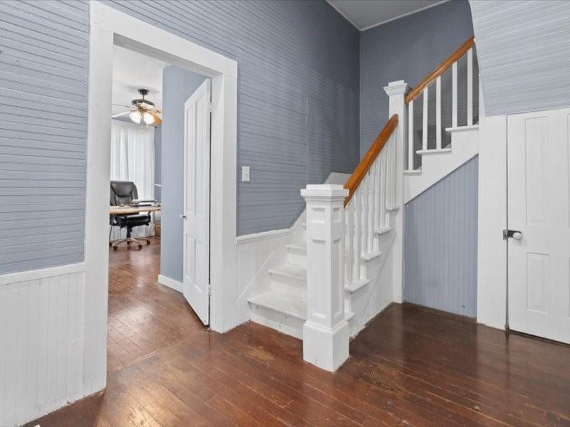 809 East Adams Street Itasca, TX 76055 - Photo 10 of 31 a view of an entryway with wooden floor and a livingroom