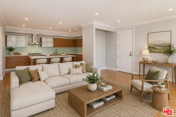 a living room with furniture kitchen view and a table