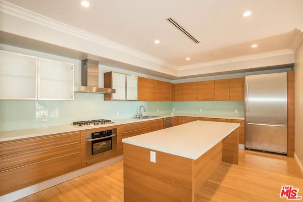 a kitchen with stainless steel appliances granite countertop a sink and a stove top oven