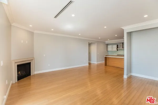 a view of an empty room with a fireplace