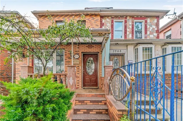 a front view of a house with large windows