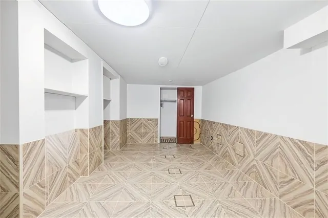 a living room with furniture and kitchen view