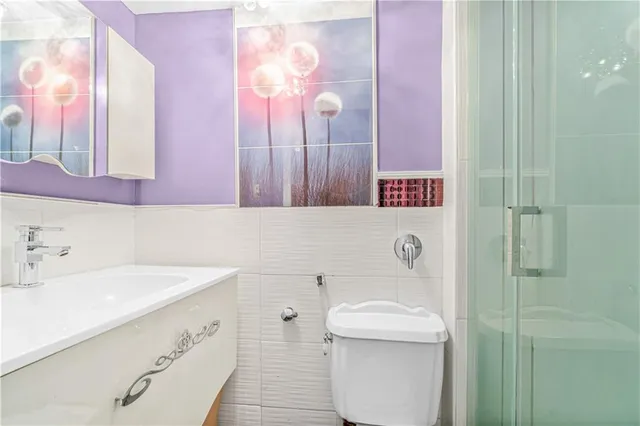 a bathroom with a sink toilet and shower