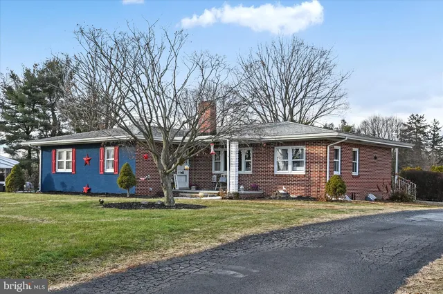 a front view of house with yard and trees