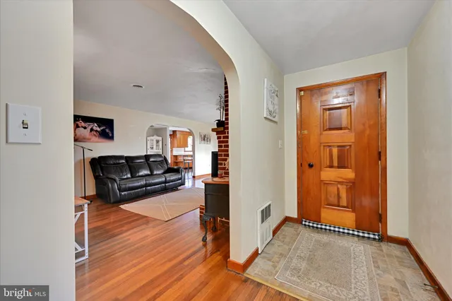 a view of living room with furniture and wooden floor