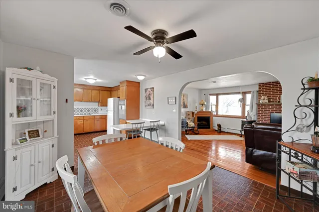 a view of a dining room with furniture and a ceiling fan