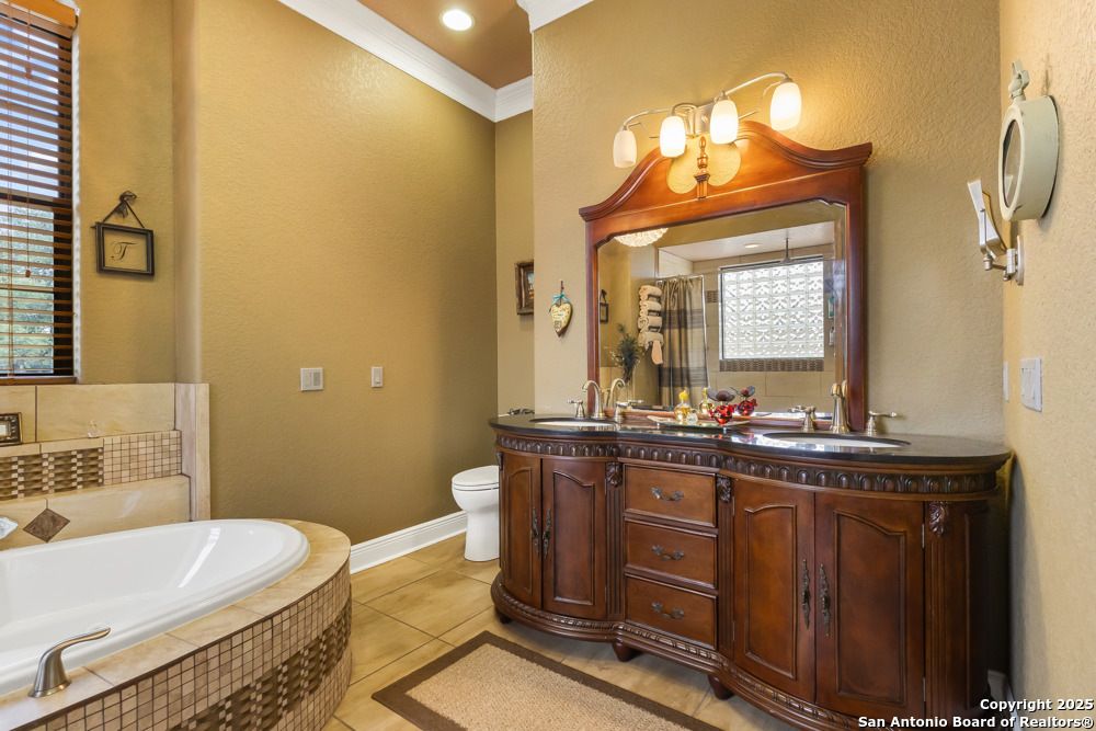 168 Bandera Boulevard Bandera, TX 78003 - Photo 20 of 39 a bathroom with a double vanity sink and a mirror