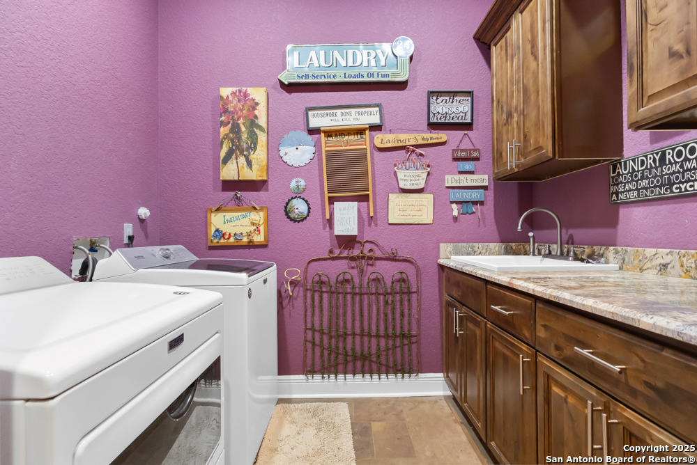 168 Bandera Boulevard Bandera, TX 78003 - Photo 24 of 39 a utility room with a sink a washer and dryer