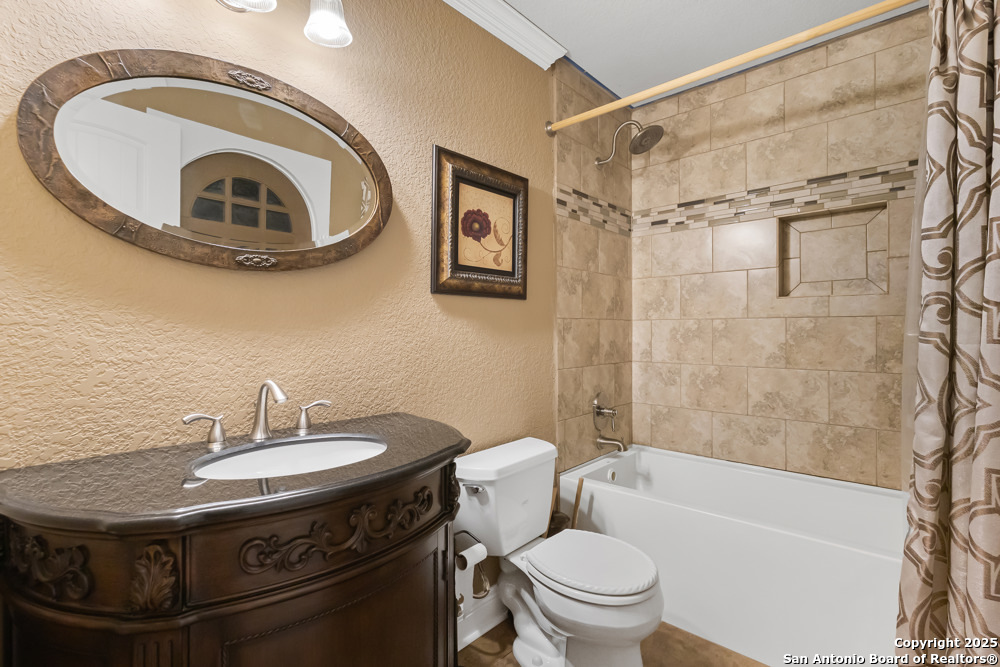 168 Bandera Boulevard Bandera, TX 78003 - Photo 25 of 39 a bathroom with a sink a toilet and a mirror