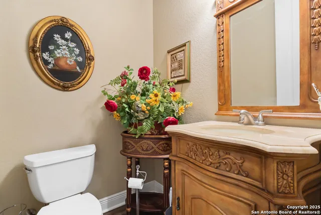a bathroom with a toilet a sink and a mirror