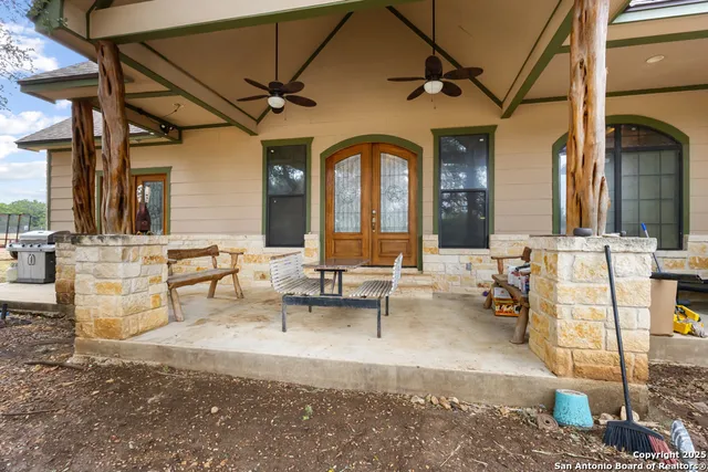 a living room with fireplace furniture and a potted plant