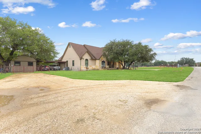 a view of a house with a yard and garage