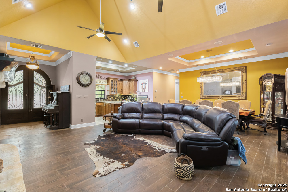 168 Bandera Boulevard Bandera, TX 78003 - Photo 10 of 39 a living room with furniture a clock and a ceiling fan