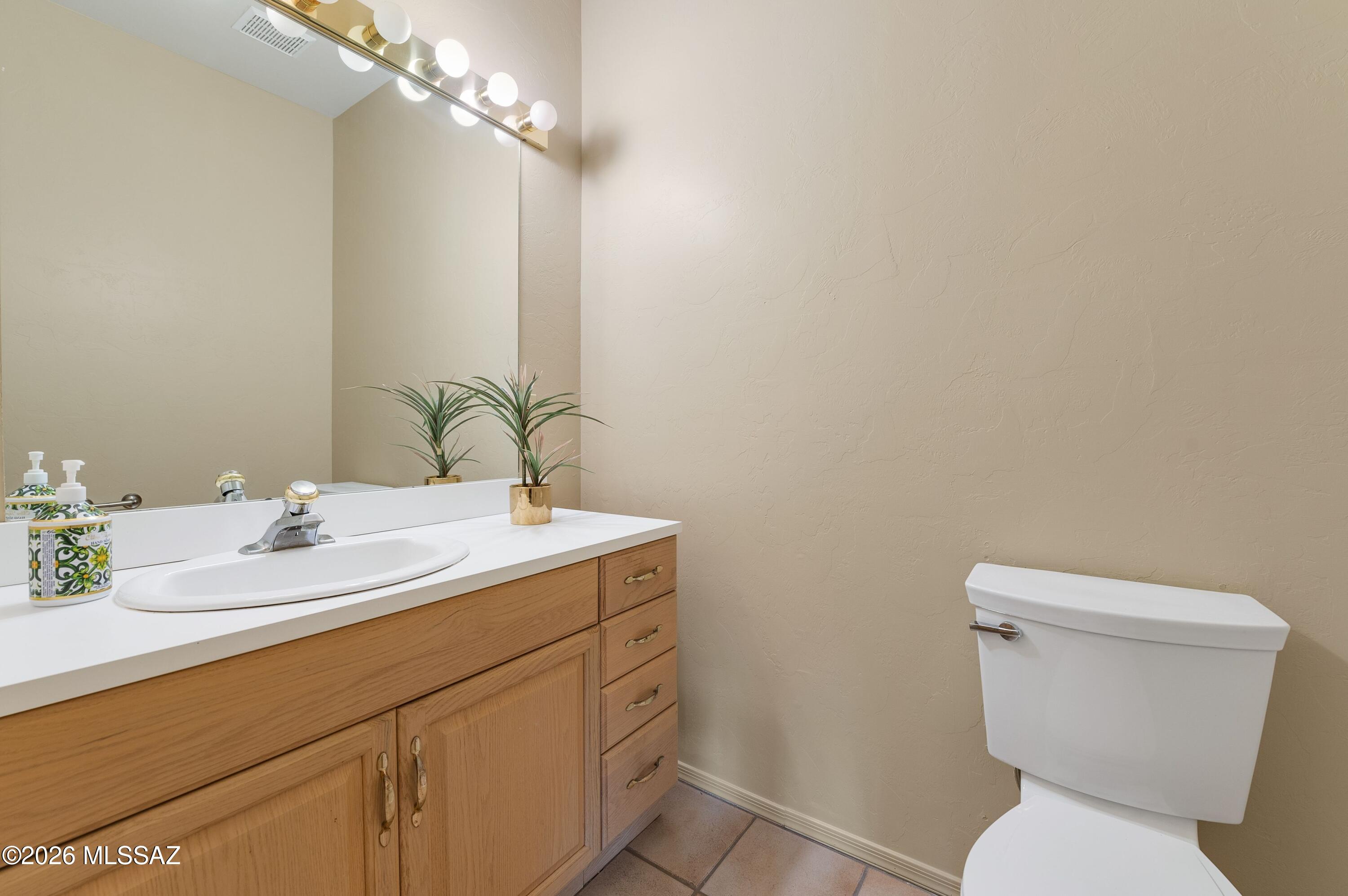 12160 East Tanque Verde Road Tucson, AZ 85749 - Photo 44 of 53 Vanity with mirror and tile flooring.